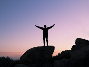 Silhouette of Man Raising His Hands